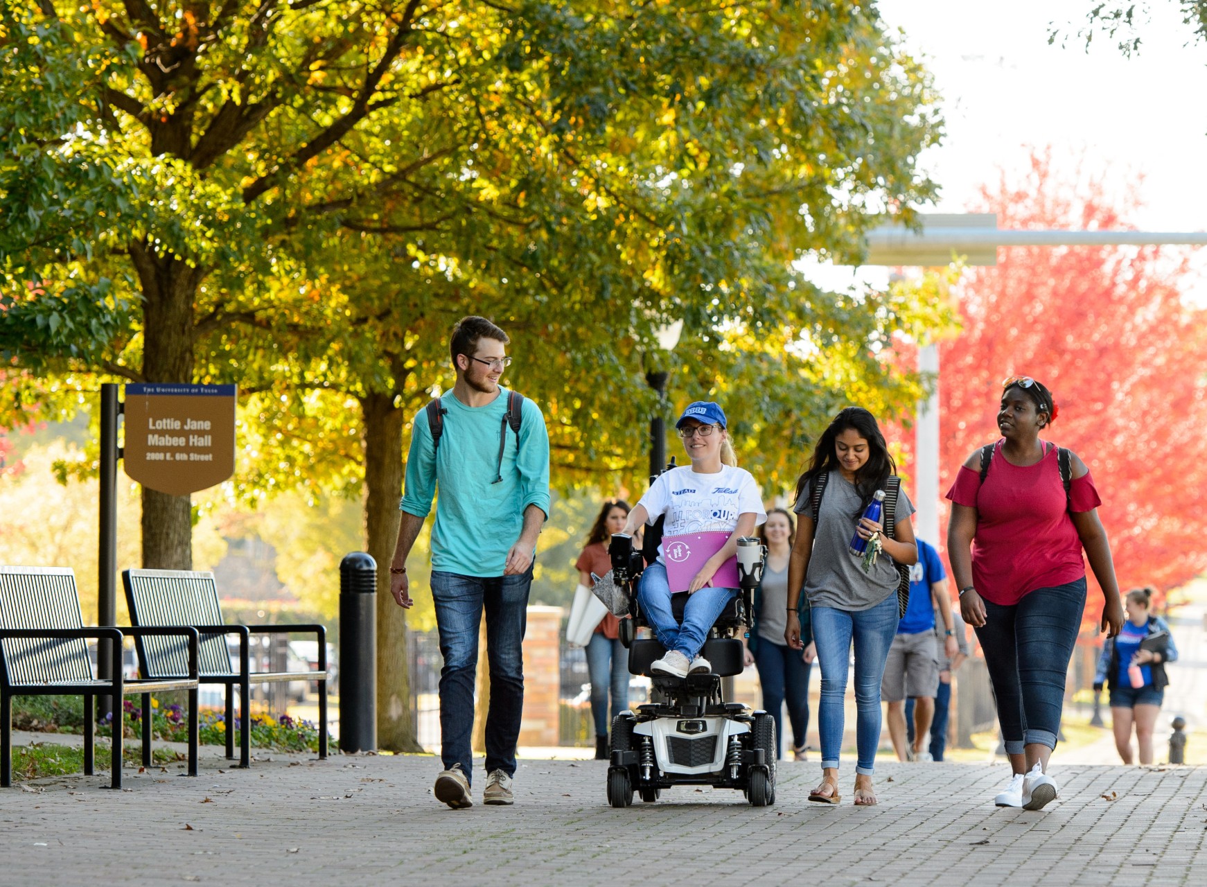 students on TU campus with fall leaves in background