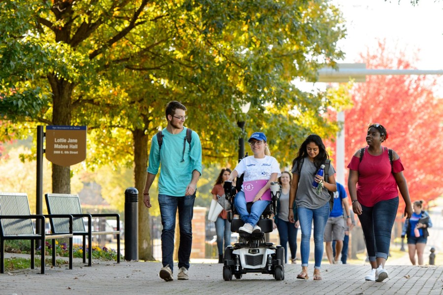 students on TU campus with fall leaves in background