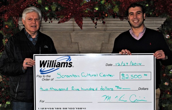 Williams employee Vince (left) presents Williams' donation to Paul Wendolowski, president of the SCC Board of Directors.