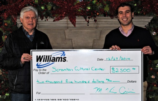 Williams employee Vince (left) presents Williams' donation to Paul Wendolowski, president of the SCC Board of Directors. 