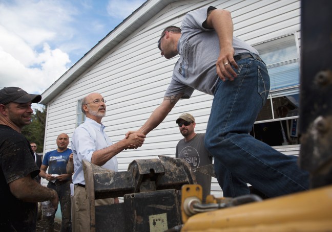 Pennsylvania Governor, Tom Wolf shakes hands with Tom Reagen of Dunbar Twp. during his visit to Connellsville. Photo credit: Herald-Standard