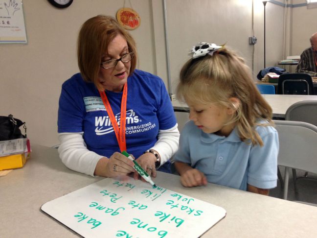 Beth Stewart volunteers an hour each week to help Hayden, a first grader at Sequoyah Elementary, improve her reading skills. Most students show dramatic improvement – many a grade year or more – after participating for a school year in Reading Partners. 