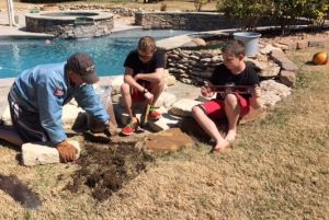 Steve Beatie building landscape wall with sons