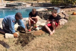 Steve Beatie building landscape wall with sons