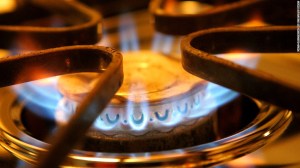 up close photo of gas top stove burner with blue flame