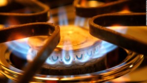 up close photo of gas top stove burner with blue flame