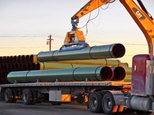 pipes being loaded on a truck