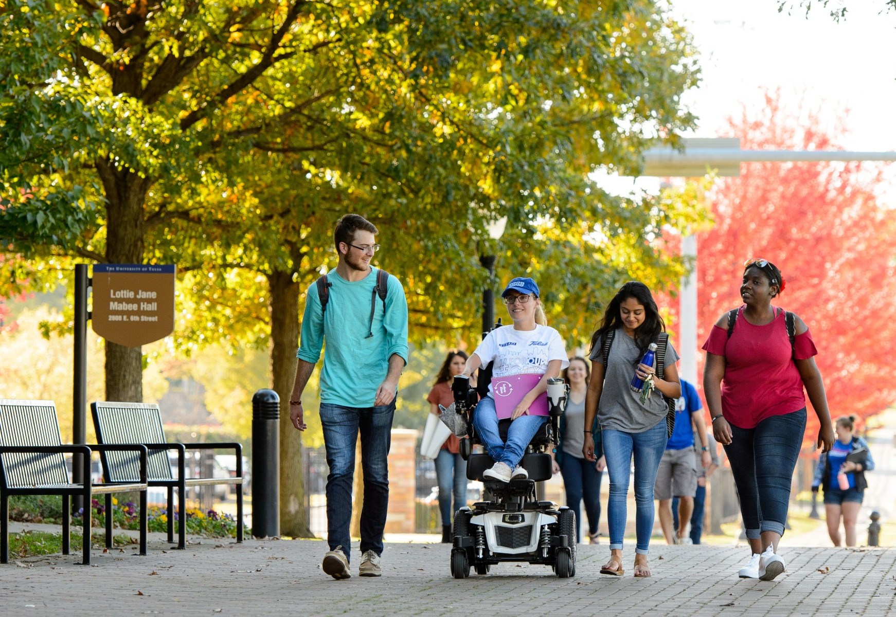 students on TU campus with fall leaves in background