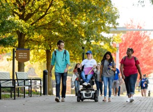 students on TU campus with fall leaves in background