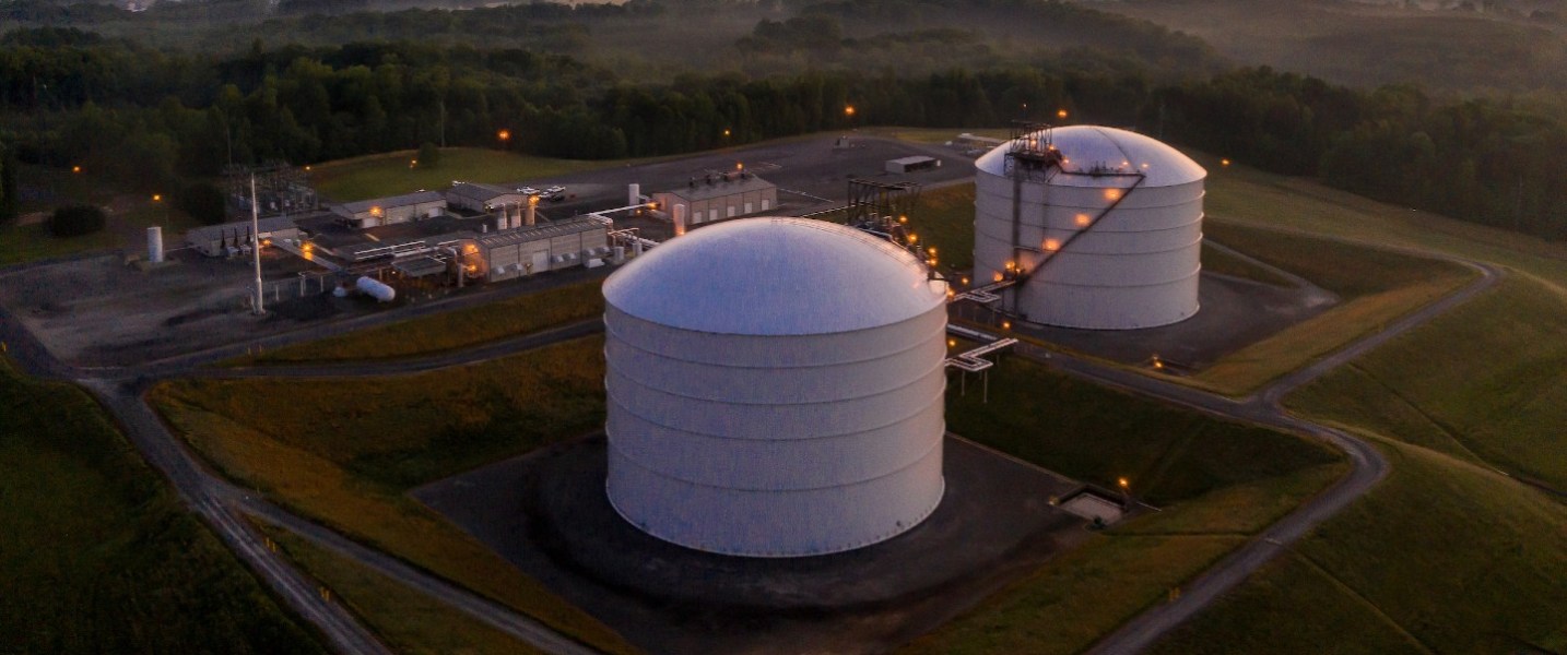 Liquid natural gas storage tanks at sunrise.